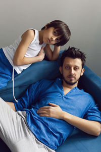 High angle view of boy sleeping on bed at home