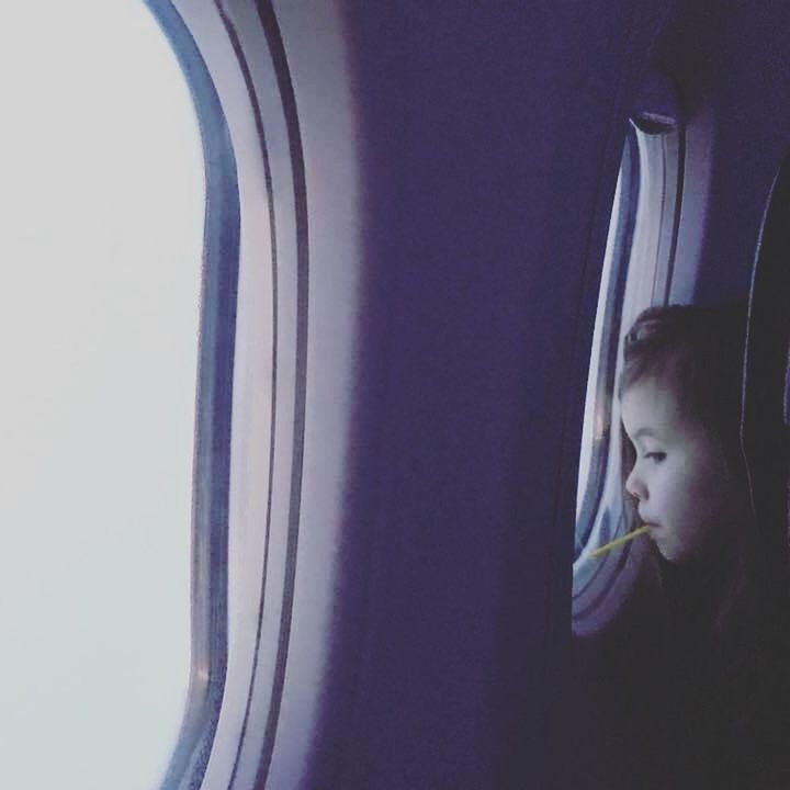 PORTRAIT OF CUTE BOY IN AIRPLANE