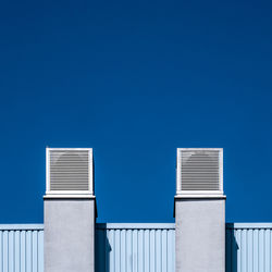 Low angle view of building against clear blue sky