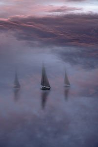 Low angle view of sea against sky during sunset