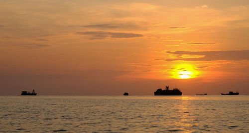 Scenic view of sea against orange sky