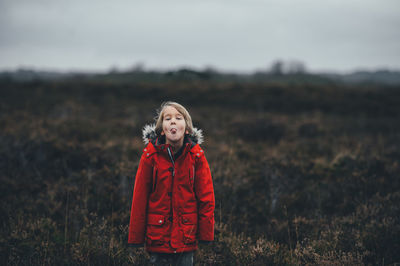 Portrait of smiling boy standing on field