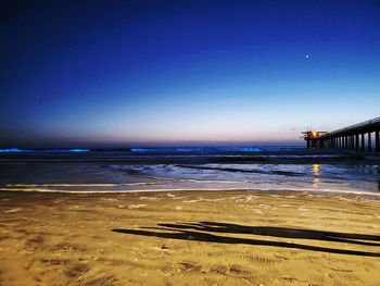 Scenic view of sea against clear blue sky