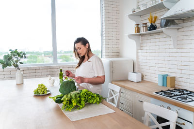 Young woman holding food on table