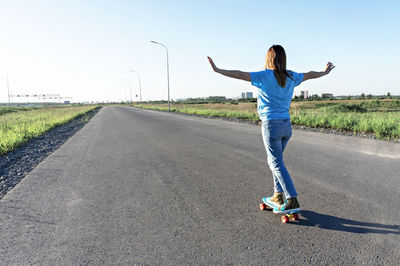 Full length of man standing on road against sky