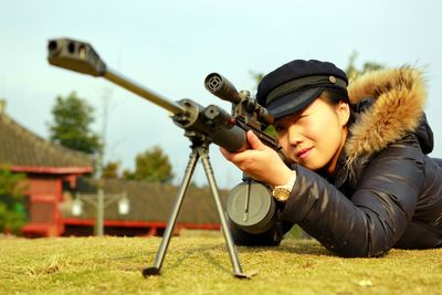 Woman with sniper on field