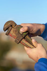 Cropped hand of person holding equipment