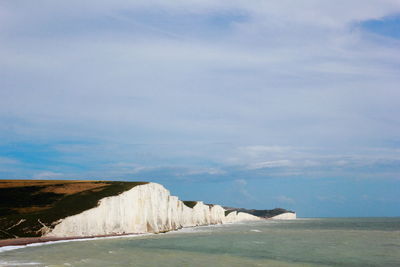 Scenic view of sea against cloudy sky