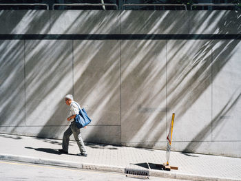 Full length of woman standing by railing