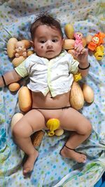 Full length of cute baby relaxing on bed