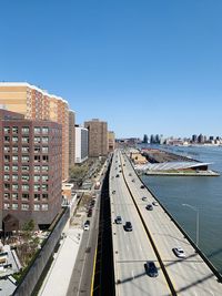 High angle view of street amidst buildings against clear sky