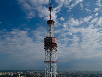 Low angle view of communications tower against sky