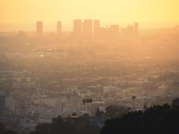 High angle view of buildings in city during sunset