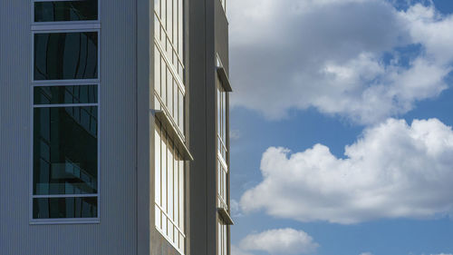 Low angle view of building against cloudy sky