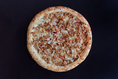 Close-up of pizza against black background