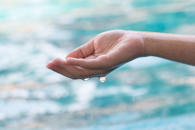 Close-up of hand on water