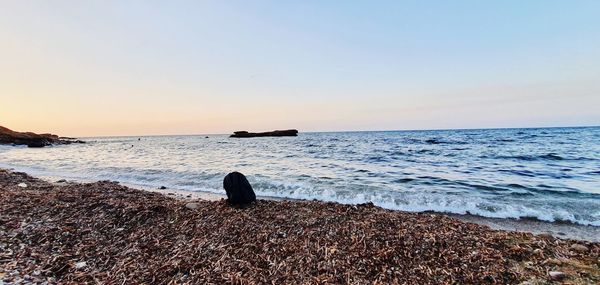 Scenic view of sea against clear sky during sunset