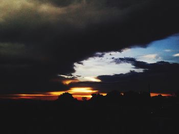 Silhouette of landscape against dramatic sky