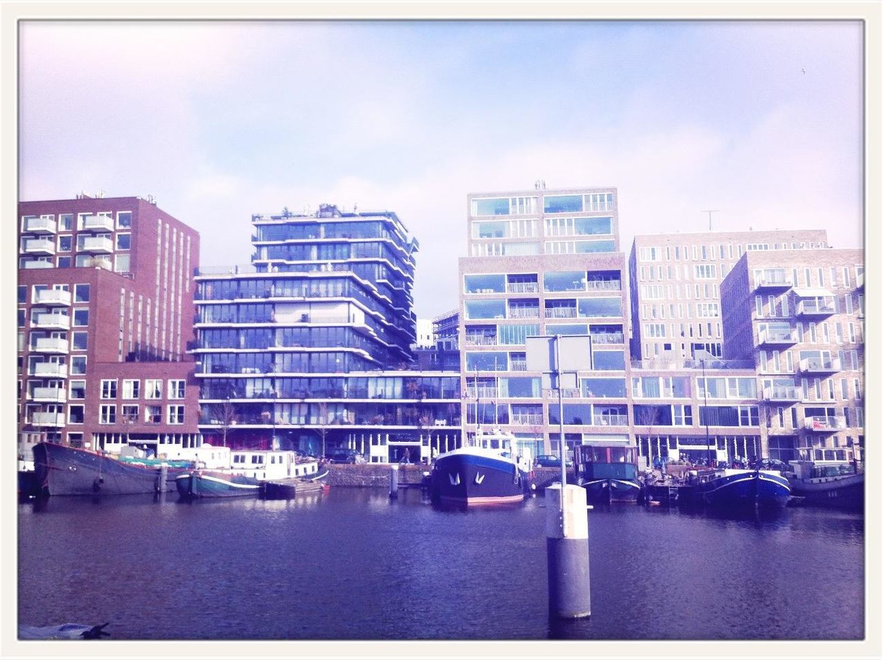 building exterior, transportation, nautical vessel, architecture, waterfront, mode of transport, water, built structure, boat, city, moored, transfer print, sky, river, auto post production filter, building, harbor, day, canal, reflection