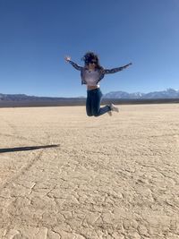 Full length of person paragliding in desert