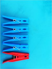 High angle view of colored pencils on blue table