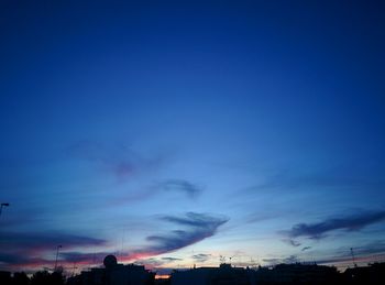 Buildings against blue sky at dusk