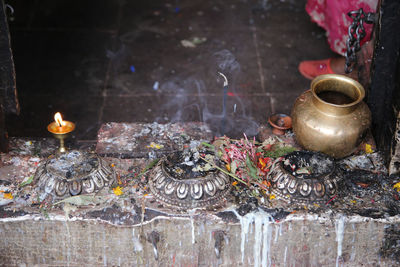 High angle view of lota with religious offerings at buddhist temple