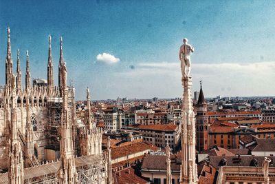 Panoramic view of city buildings against cloudy sky