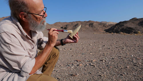 Archaeologist at work in the desert 