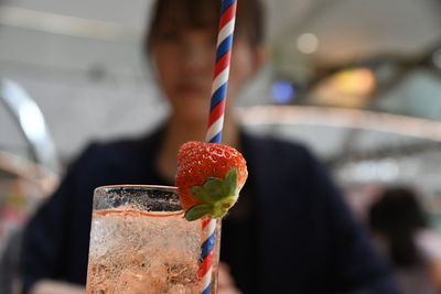 Close-up of strawberry holding ice cream