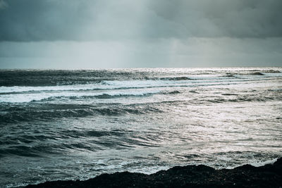 Scenic view of sea against cloudy sky