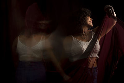 Time lapse view of woman moving a rag. long exposure, motion blur. happy woman. salvador, brazil.