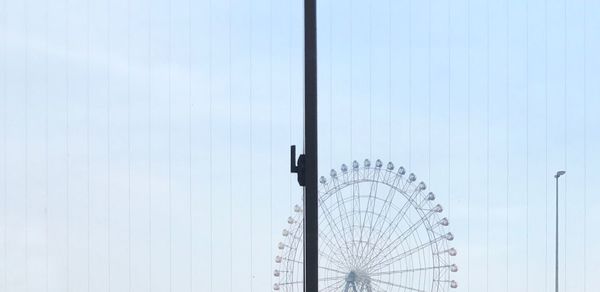 Low angle view of ferris wheel against clear sky