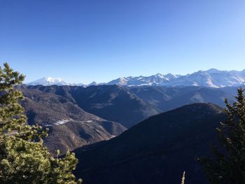 Scenic view of mountains against clear blue sky