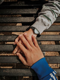 Cropped image of couple holding hands on table