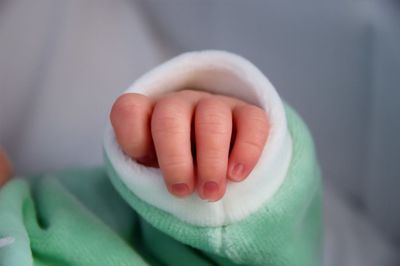 Close-up of young woman holding hands