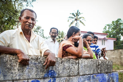 Group of people sitting against the sky