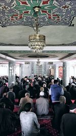 Rear view of people on ceiling