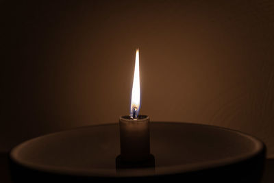 Close-up of illuminated lamp against black background