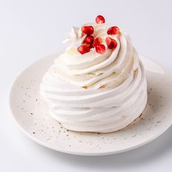 Close-up of cake in plate against white background