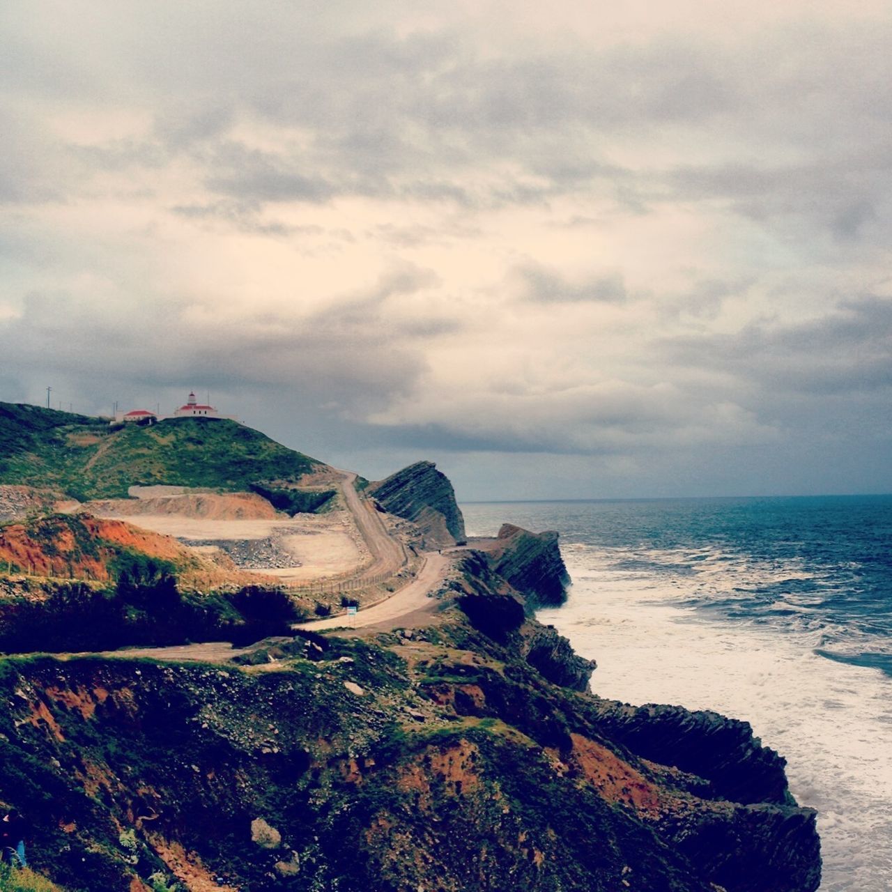 sea, sky, horizon over water, water, tranquil scene, scenics, tranquility, beauty in nature, cloud - sky, nature, cloudy, cloud, rock - object, coastline, cliff, idyllic, beach, rock formation, shore, landscape