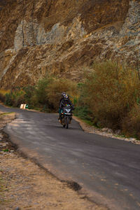 Man riding motorcycle on road