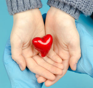 Close-up of woman holding heart shape