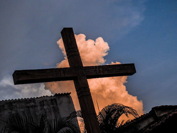 Low angle view of cross against sky