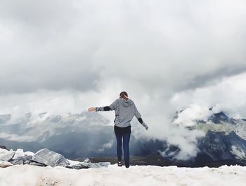 Rear view of woman standing on snow covered landscape