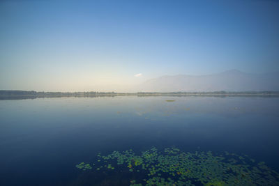 Scenic view of lake against blue sky