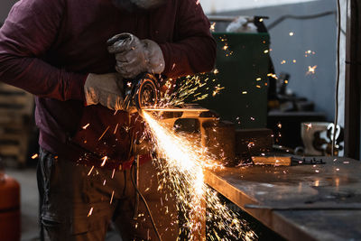 Man working on metal grate