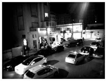 Cars parked on road at night