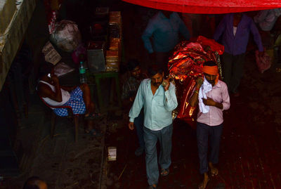 People standing in market at night