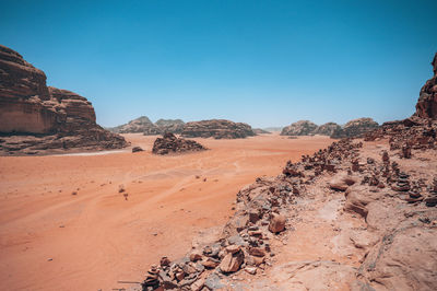 Scenic view of desert against clear blue sky